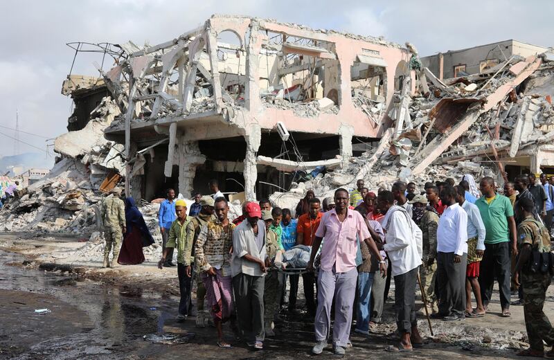 Civilians carry the body of a man killed in the blast. Feisal Omar / Reuters