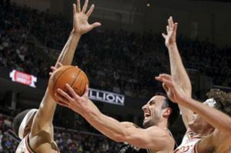 Manu Ginobili of the San Antonio Spurs, centre, is given no room by the Cleveland Cavaliers.