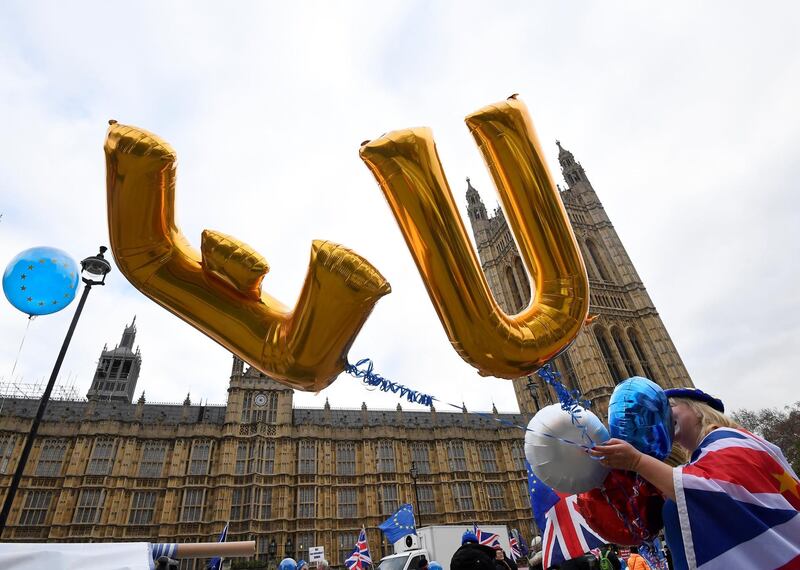 An anti-Brexit protester holds balloons opposite the Houses of Parliament in London, Britain, December 10, 2018. REUTERS/Toby Melville