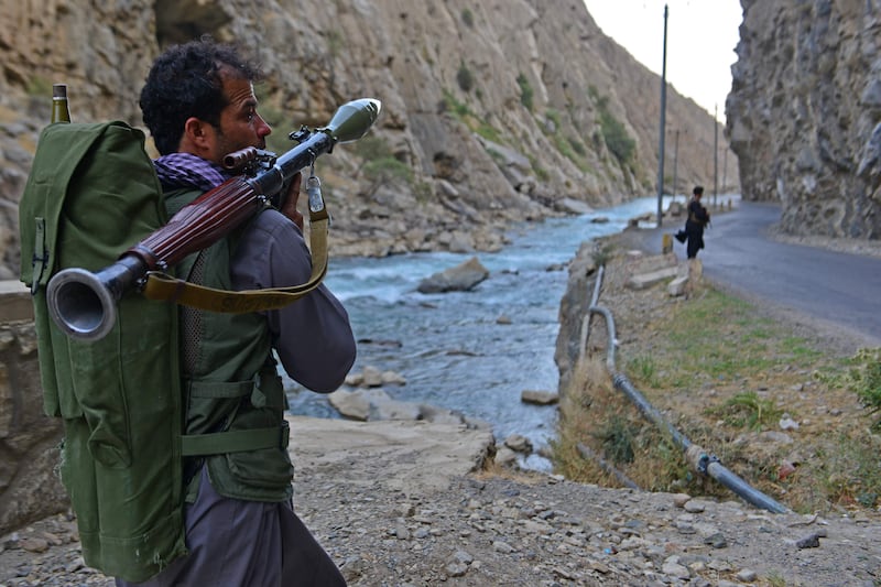 An Afghan resistance movement fighter stands guard on a road in Rah-e Tang. AFP