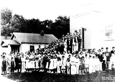 An undated photograph of the Cedar Rapids Muslim community standing in front of the Mother Mosque of America. Photo: The History Centre, Linn County Historical Society