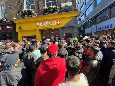 Customers congregate at the doors to the closed Swatch store on Carnaby Street, central London, after chaos broke out at the launch of the MoonSwatch