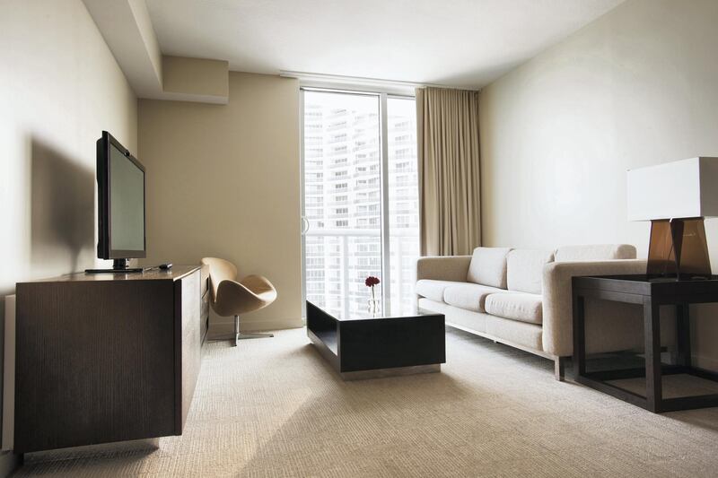 "Sofa, coffee table and television in modern hotel room"