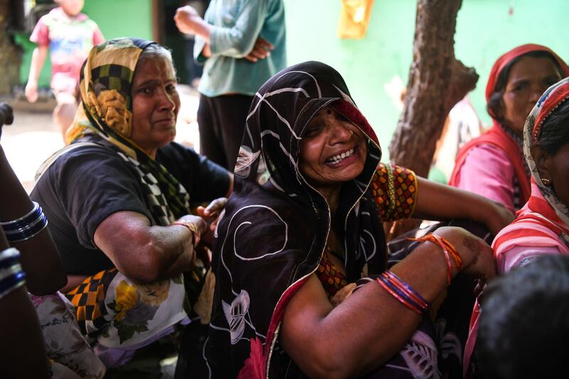 Relatives mourn Sunil Kumar, 24, who died after getting crushed under the debris of a ceiling that fell in heavy storm winds in Kheragarh on the outskirts of Agra. Chandan Khanna / AFP