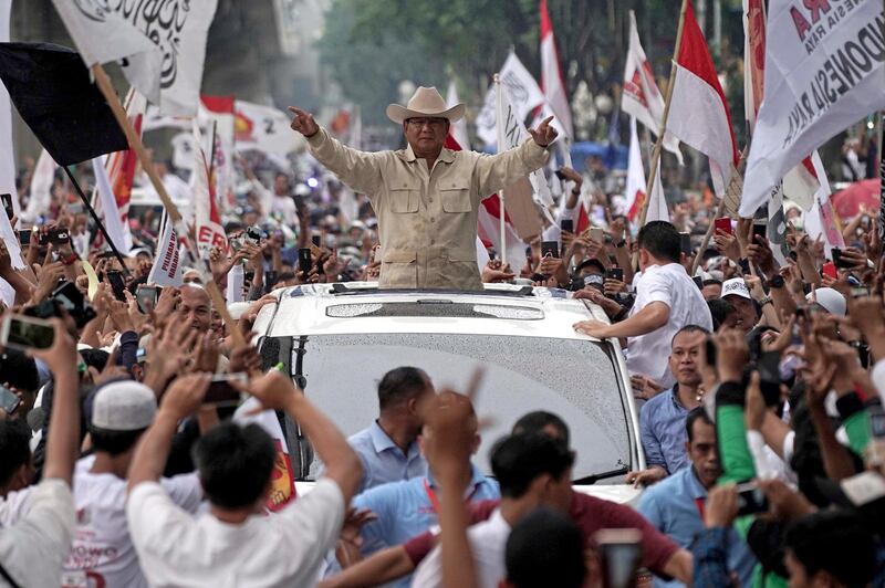Presidential candidate Prabowo Subianto gestures to supporters from a vehicle during a campaign rally in Palembang, South Sumatra province, Indonesia, on Tuesday, April 9 2019. Bloomberg