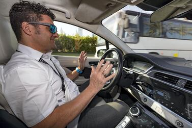 Jim O'Donoghue, a Jaguar safety driver, oversees the autonomous journey of a Jaguar iPace during a demonstration at the Dubai World Congress for Self-Driving Transport. Chris Whiteoak / The National