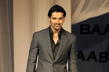 Indian film actor John Abraham walks the ramp at the music launch of the film "Babul" in Mumbai, late 26 October 2006. Film production house B.R.Films celebrated its 50th year in the film industry and released its latest film's 'Babul' music CD with a fashion show in which the lead star cast took part. AFP PHOTO/Sebastian D'SOUZA (Photo by SEBASTIAN D'SOUZA / AFP)