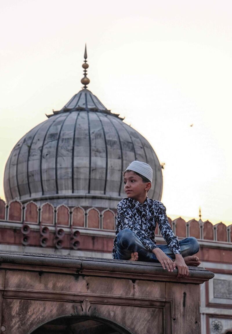 In this picture taken an Indian young Muslim looks on as he waits to break his fast during the Islamic holy month of Ramadan at Jama Masjid in New Delhi.  AFP