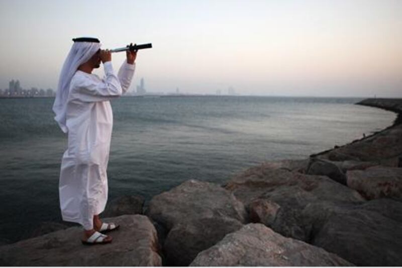 A Member of the official Moon Spotting Committee Ali al Habshi meet at Mina Port to look for the moon to signal the start of eid.  (Galen Clarke/The National)