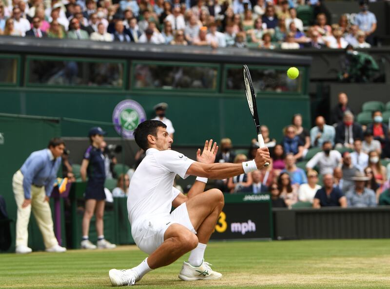 Novak Djokovic returns from an unlikely position. EPA