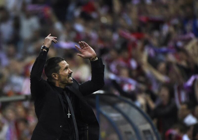 Atletico Madrid coach Diego Simeone reacts during his side's Champions League victory over FC Barcelona. Pierre-Philippe Marcou / AFP / April 9, 2014
