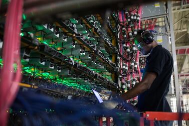 A technician monitors cryptocurrency mining rigs. Security and regulatory concerns have plagued the virtual currency for much of this year. Bloomberg