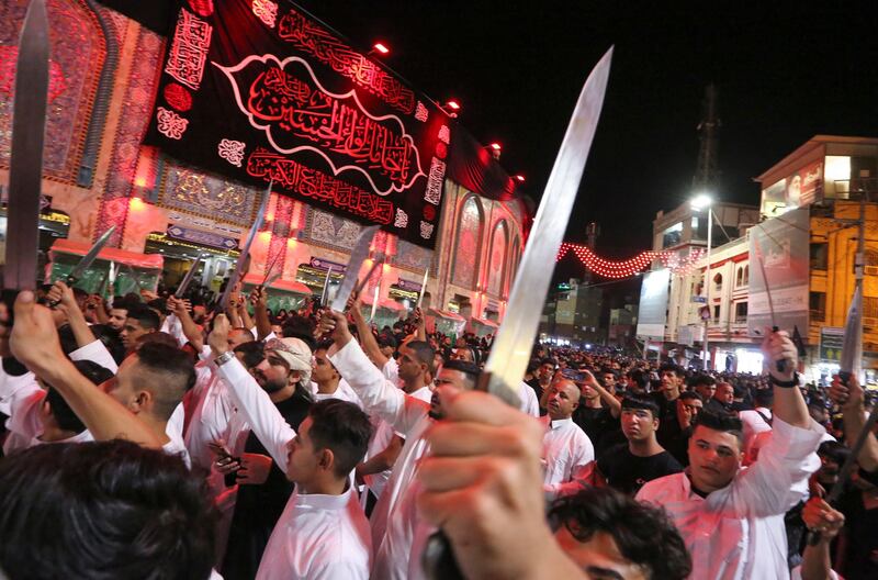 Shiites brandish knives during Tatbir processions near a shrine in Karbala, Iraq.