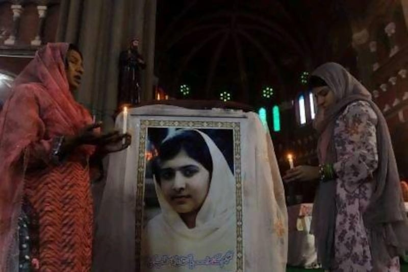 Pakistani Christians attend a mass praying for the recovery of child activist Malala Yousafzai at a church in Lahore, Pakistan.