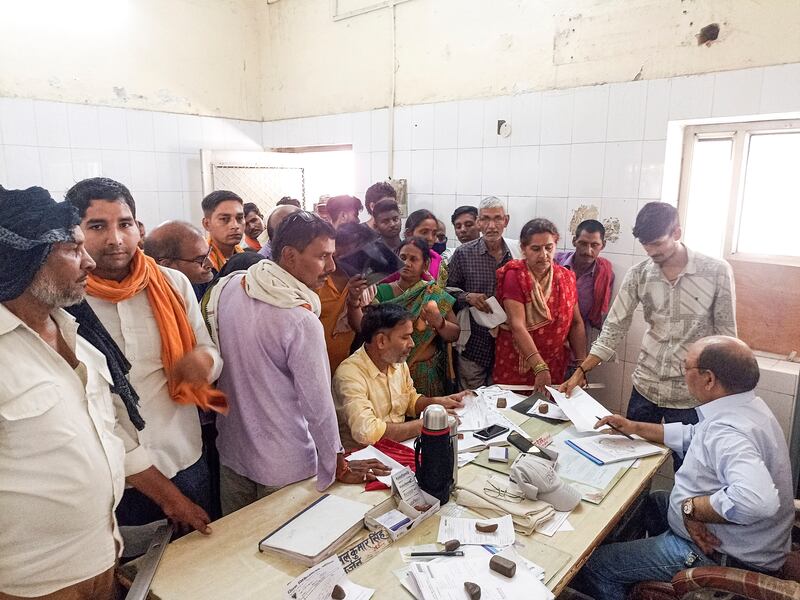 People crowd round a hospital desk in Ballia district