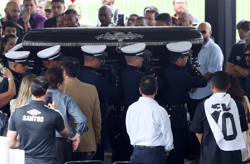 Pallbearers carry the casket of Pele at Santos' Urbano Caldeira Stadium. Reuters
