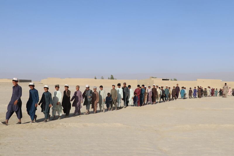 Afghan children attend an educational event organised by Pen Path, a civil society initiative providing education to Afghan children in areas where there is no school, in Kandahar, Afghanistan. 