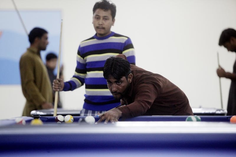 Workers play pool in one of the recreation centres. Christopher Pike / The National