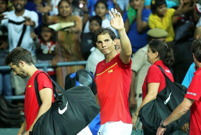 Rafael Nadal waves to the crowd after partnering Marc Lopez to doubles victory against India. Rajat Gupta / EPA