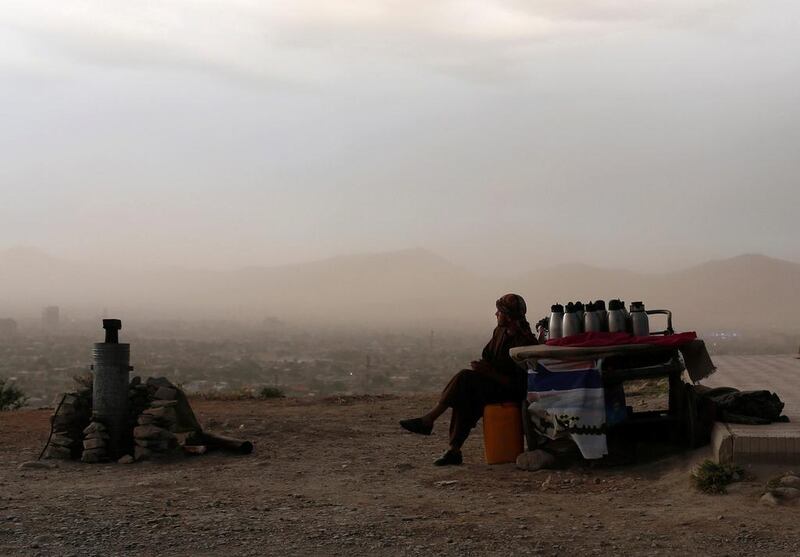 An Afghan man waits for customers at a tea stall on a hilltop, where people come for strolls, in Kabul on June 4. Ahmad Masood / Reuters