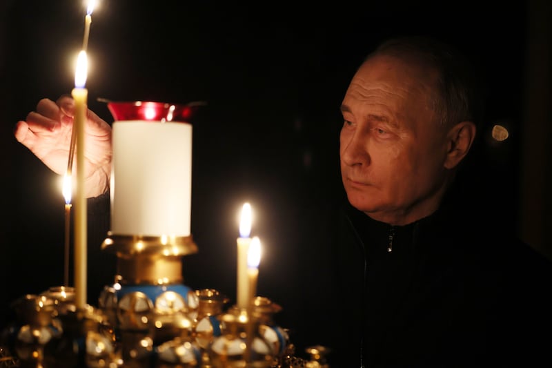Russian President Vladimir Putin lights a candle to commemorate the victims of a terrorist attack on the Crocus City Hall concert venue on a day of national mourning in Moscow. EPA