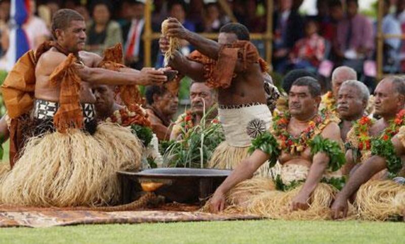 Fijian men prepare kava during a welcome ceremony.