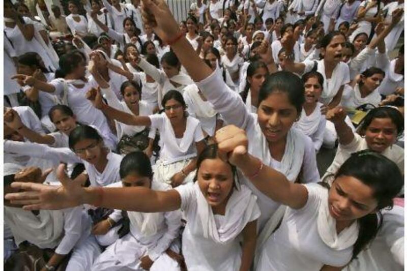 Supporters of activist Anna Hazare shout slogans during a protest against corruption in Jammu Saturday. India's parliament edged closer to an agreement on Saturday on an anti-corruption bill.