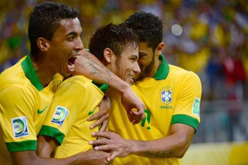 Neymar, centre, was a happy man after Brazil beat Italy, but he refused to get carried away. Christophe Simon / AFP