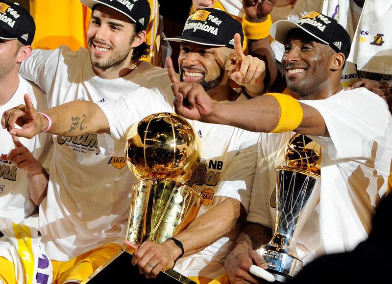 os Angeles Lakers guard Derek Fisher, center, holds the Larry O'Brien Trophy as Kobe Bryant, right, holds the MVP trophy as they celebrate after beating the Boston Celtics, 83-79, in Game 7 of the NBA basketball finals in Los Angeles. AP Photo/Mark J. Terrill