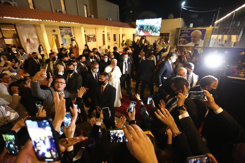 Pope Francis greets people as he leave the Chaldean Cathedral of Saint Joseph. Getty Images