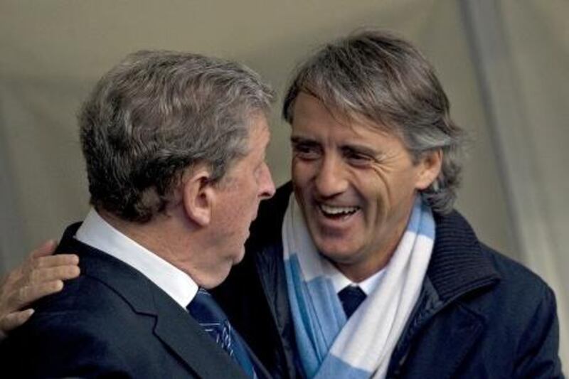 Manchester City's Italian manager Roberto Mancini (R) talks with West Bromwich Albion's English manager Roy Hodgson (L) ahead of the English Premier League football match between Manchester City and West Bromwich Albion at The Etihad stadium in Manchester, north-west England on April 11, 2012. AFP PHOTO/ADRIAN DENNIS 

RESTRICTED TO EDITORIAL USE. No use with unauthorized audio, video, data, fixture lists, club/league logos or ìliveî services. Online in-match use limited to 45 images, no video emulation. No use in betting, games or single club/league/player publications.
 *** Local Caption ***  284493-01-08.jpg