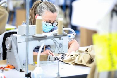 A machinist sews a protective gown for a worker in the U.K. National Health Service (NHS) at the Burberry Group Plc factory in Castleford, U.K., on Tuesday, April 21, 2020. The U.K. ran the risks running out of protective equipment for its hospital staff as half the doctors working in high-risk areas reported supply shortages in an April survey by the British Medical Association. Photographer: Chris Ratcliffe/Bloomberg
