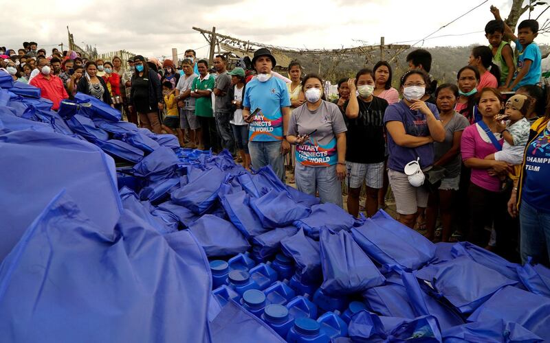 Residents, who refuse to evacuate, queue for relief goods. Joseph Campbell / Reuters