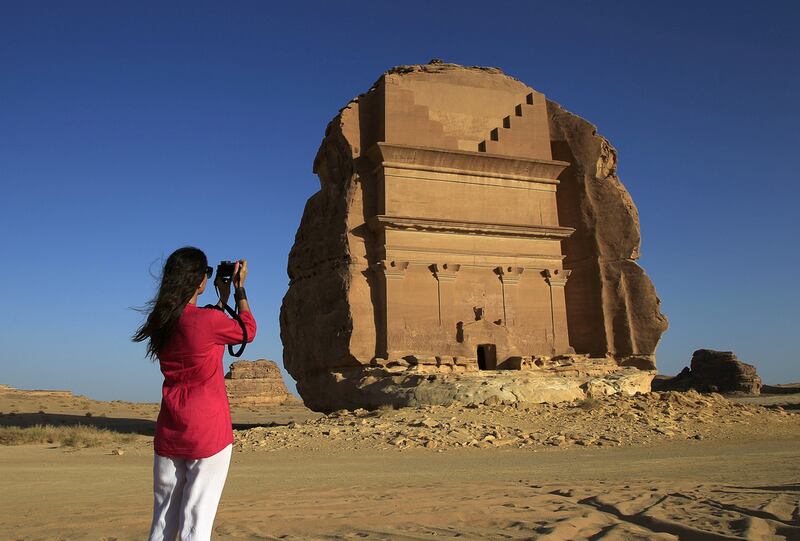 13. A tourist visits the Abu Lawha Nabataean tomb at the desert archaeological site of Hegra, north-west of Riyadh, Saudi Arabia. AP Photo