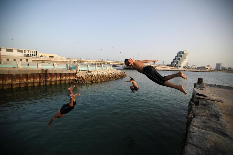 Yong people enjoy a swim and cool off, during the outbreak of the coronavirus disease in Manama. Etihad and Emirates resumed flight to Bahrain in June. Reuters