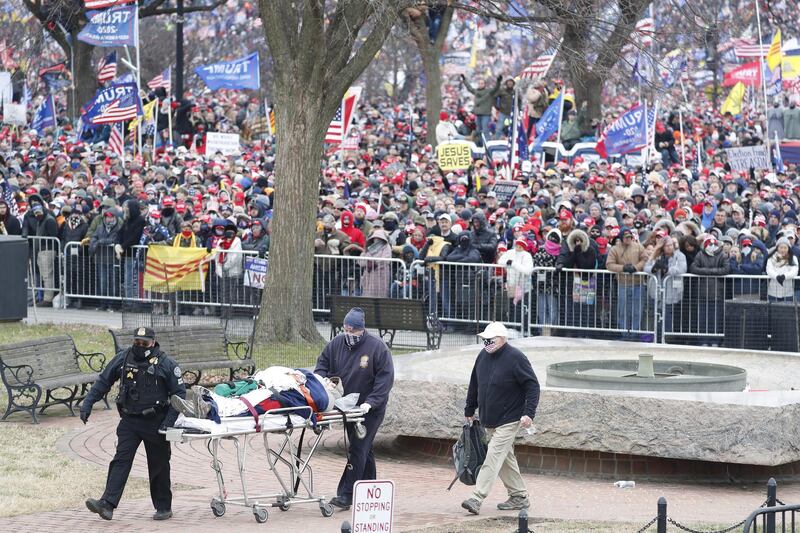 A person is removed on a stretcher as US President Donald J Trump delivers remarks to supporters gathered to protest Congress' upcoming certification of Joe Biden as the next president on the Ellipse in Washington, DC, USA. EPA