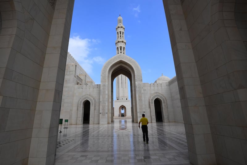 A worshipper walks at Sultan Qaboos Grand Mosque in Muscat.  AFP