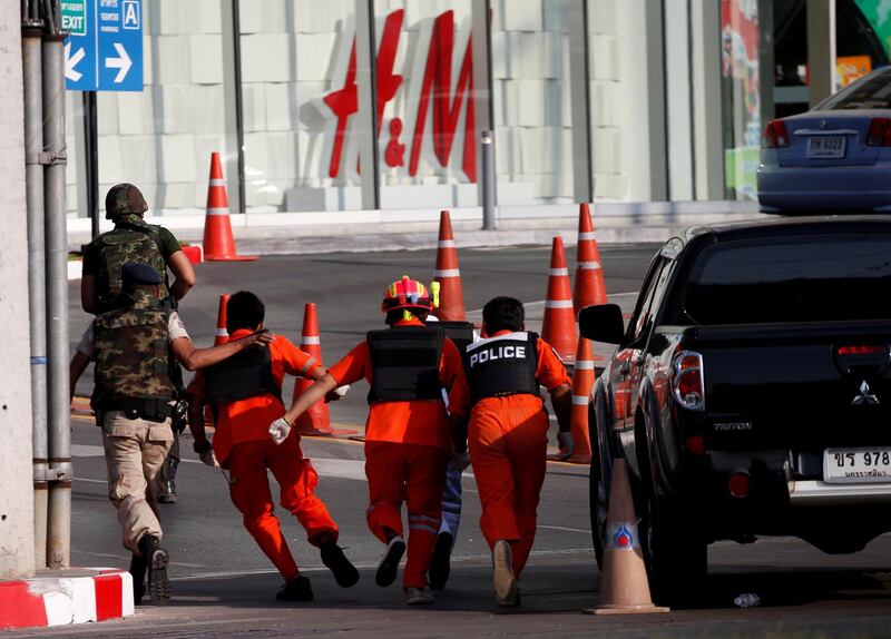Soldiers cover rescue workers as they proceed to enter Terminal 21 shopping mall following a gun battle involving a Thai soldier on a shooting rampage, in Nakhon Ratchasima, Thailand. REUTERS
