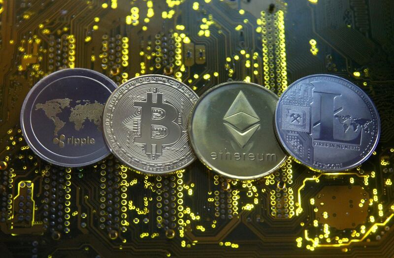 FILE PHOTO: Representations of the Ripple, bitcoin, etherum and Litecoin virtual currencies are seen on a PC motherboard in this illustration picture, February 14, 2018. REUTERS/Dado Ruvic/Illustration/File Photo/File Photo