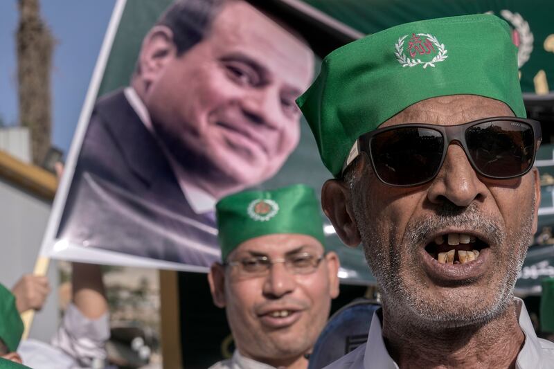 Egyptians celebrating the birth of the Prophet Muhammad with banners supporting President Abdel Fattah El Sisi in the December presidential elections. AP