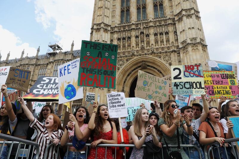 Climate change demonstrators hold placards during a march supported by Extinction Rebellion outside the Houses of Parliament in London, Britain May 24, 2019. REUTERS/Simon Dawson