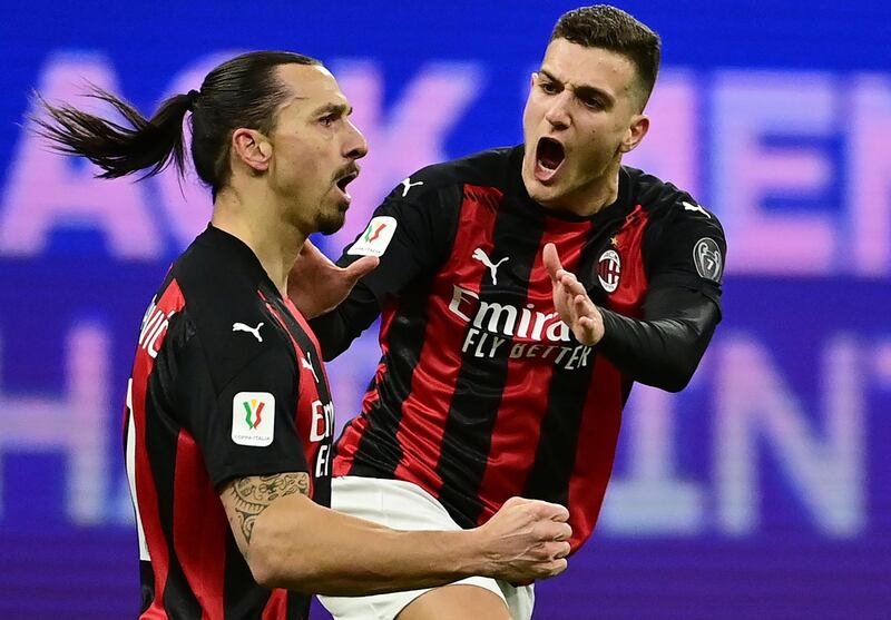 AC Milan's Zlatan Ibrahimovic celebrates with teammate Alessio Romagnoli after opening the scoring in the 31st minute. AFP
