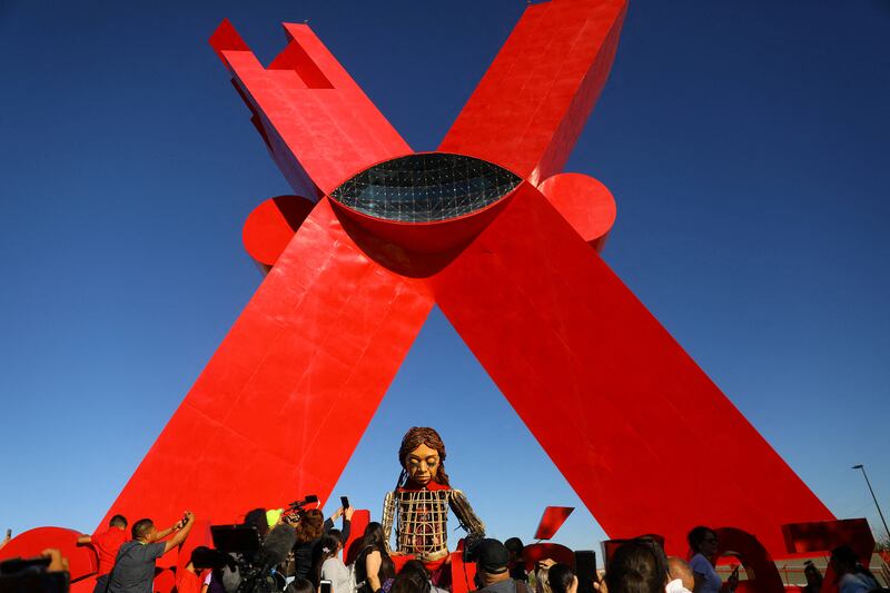 People gather around Little Amal, a 3.5m puppet depicting a 10-year-old Syrian refugee, during her journey along the US-Mexico border at Plaza de la Mexicanidad in Ciudad Juarez, Mexico. Reuters
