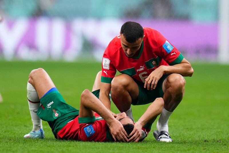 Morocco's Romain Saiss consoles Achraf Hakimi at the end of the match. AP