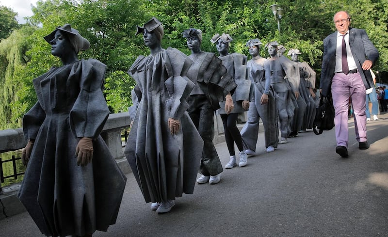 Artists of Romania's Masca theatre wear outfits inspired by famous Romanian sculptor Constantin Brancusi's iconic Endless Column, at the Living Statues International Festival, in Bucharest, Romania. Vadim Ghirda / AP Photo