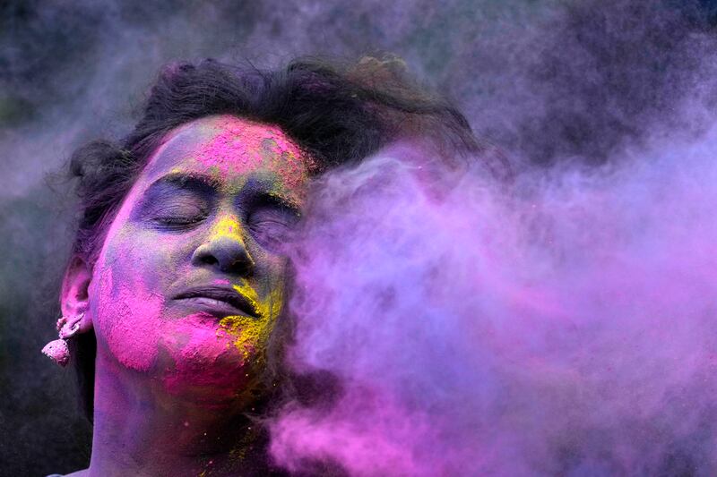 A woman celebrates Holi, the Hindu festival of colours, in Mumbai.  AP