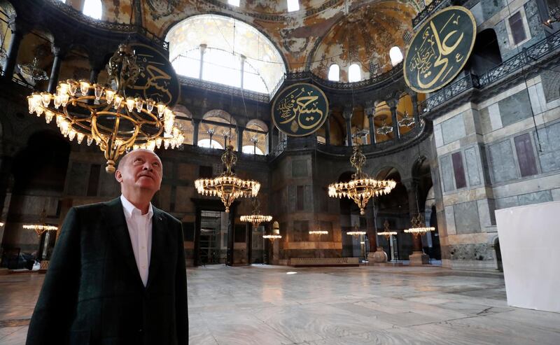 Turkey's President Recep Tayyip Erdogan visits the Byzantine-era Hagia Sophia, one of Istanbul's main tourist attractions in the historic Sultanahmet district of Istanbul, Sunday, July 19, 2020, days after he formally reconverted Hagia Sophia into a mosque and declared it open for Muslim worship, after a high court annulled a 1934 decision that had made the religious landmark a museum.(Turkish Presidency via AP, Pool)