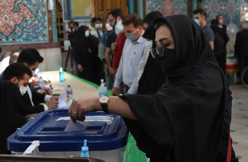 A voter casts her ballot for the presidential elections at a polling station in Tehran, Iran. AP Photo
