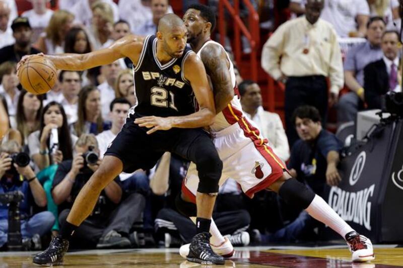 San Antonio Spurs  forward Tim Duncan (21) dribbles the ball as Miami Heat forward Udonis Haslem (40) defends during the second half of Game 1 of the NBA Finals basketball game, Thursday, June 6, 2013 in Miami. (AP Photo/Lynne Sladky)