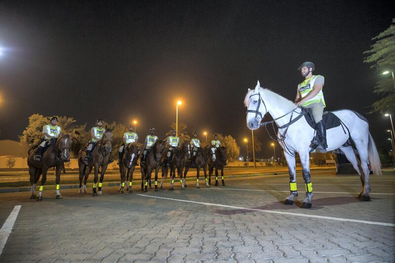 Abu Dhabi, United Arab Emirates- Police officers preparing to do patrol in a horse in Al Mushrif.  Leslie Pableo for The National for Haneen Dajani's story